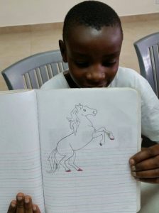 a child show's his art work